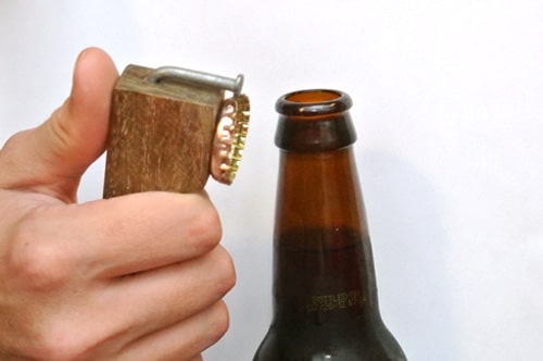 Redneck bottle opener out of a nail and scrap wood.