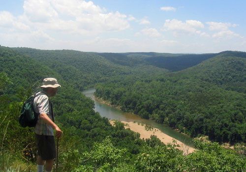 Man hiking above Buffalo national river vista.