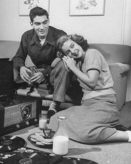 Vintage couple on date listening to records turntable. 