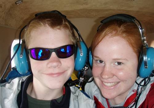 Boy and girl wearing headphones.