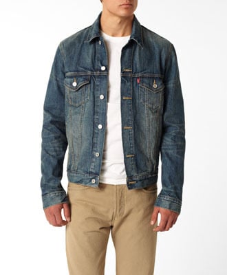 Jean denim jacket over white shirt with khaki pants. 