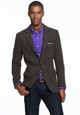 African American man black model wearing blazer with jeans and blue shirt.