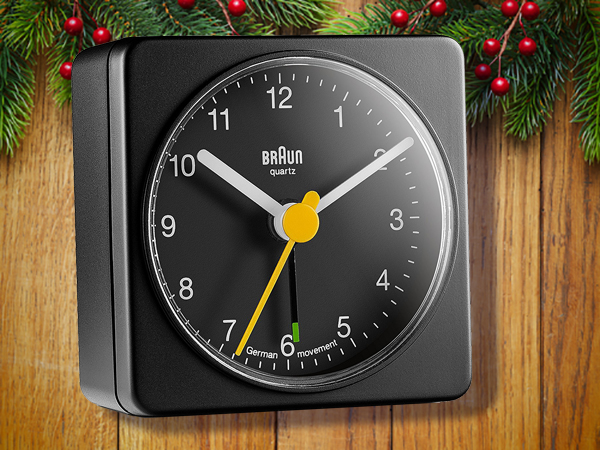 Black analog alarm clock by Braun.