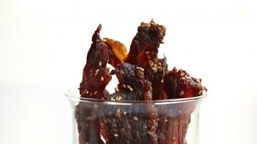 Beef jerky in the world's best glass measuring cup.