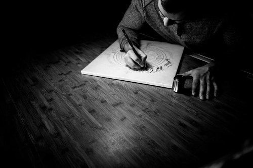 Master Penman Jake Weidmann making drawing in studio.