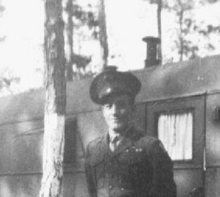 A 92-Year-Old WWII veteran in uniform giving advice next to a camper.