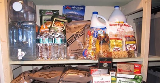 A shelf stocked with essentials for surviving a grid-down disaster, including food and other items.