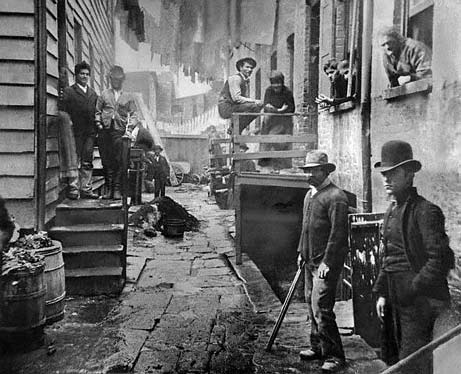 Vintage gang of working class men in alleyway.