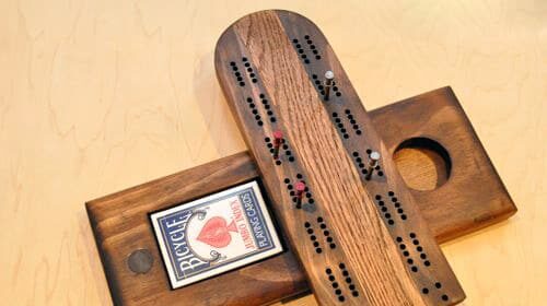 Make a cribbage board with wooden cards.
