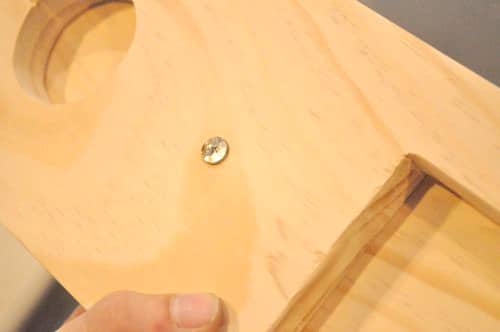 DIY wooden cribbage board with drilled a hole through the base and part-way through the top.