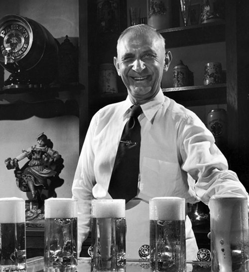 Vintage bartender serving up beers in the bar.