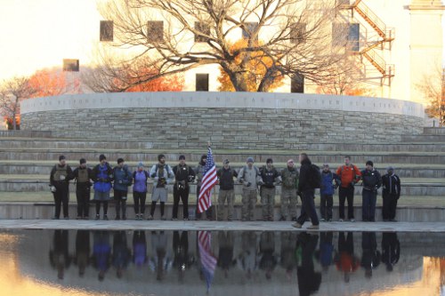 Man holding U.S.A flag with team.