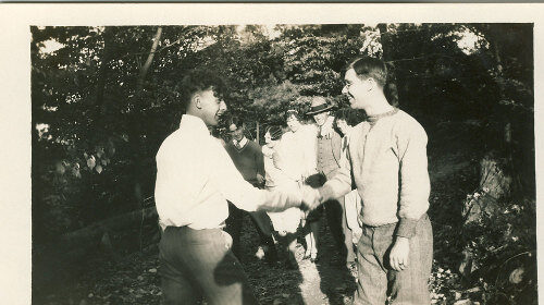 Two men exchanging compliments in the woods.