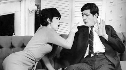 An important black and white photo of a man and woman sitting on a couch.