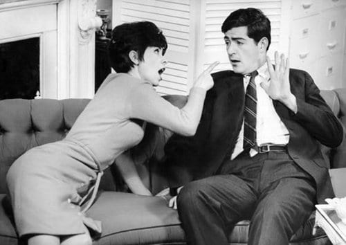 An important black and white photo of a man and woman sitting on a couch.