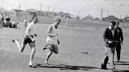 An old photo capturing men engaged in distance running across a field, shrouded in myths.