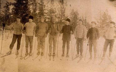 A group of skiers wearing Men's Winter Hats posing for a picture.