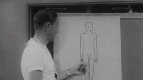 A man giving a T-testosterone primer by pointing to a drawing of a human body.