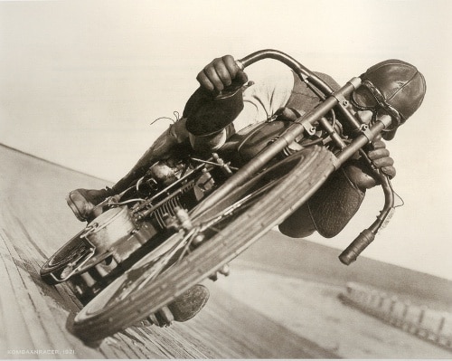 Vntage young man on motorcycle on race track. 