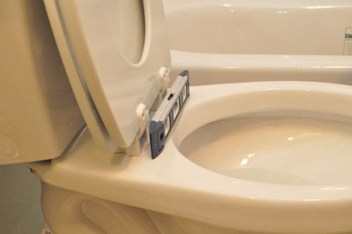 A new toilet seat leveling with level. 
