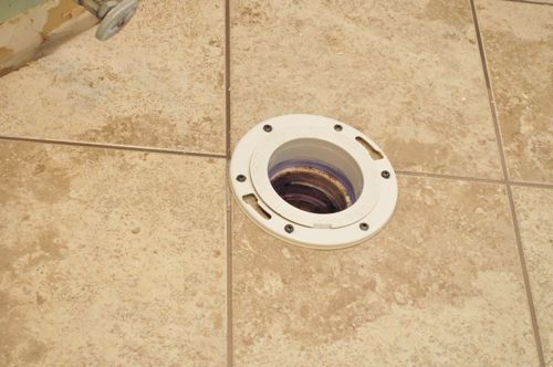 Install a new toilet preparing flange in floor. 