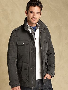 Male model wearing jacket layer and button up shirt.