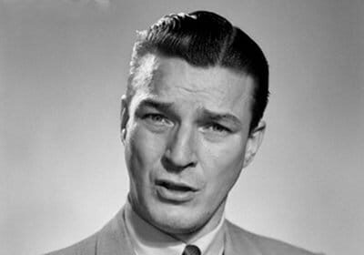 A man in a suit pointing his finger, taking personal responsibility by owning up to his mistakes.