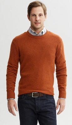 Layering sweater over button up long sleeve shirt.
