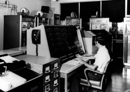 Vintage man working at large computer.