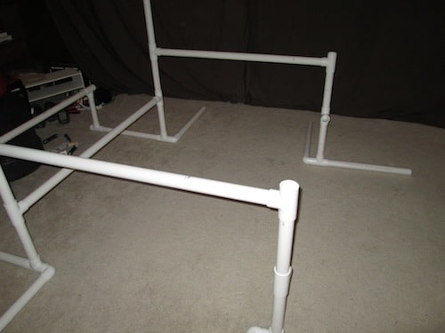Step 12: Insert a T section on top of the one foot PVC pipe and make sure the middle hole is facing inward. Then insert a 4 foot PVC pipe into the middle hole as a cross beam for your gym. Do this on both sides. 