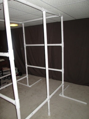 Step 23: Insert your 5 foot 3 1/2 inch PVC pipe vertically into the open T sections as shown below. 