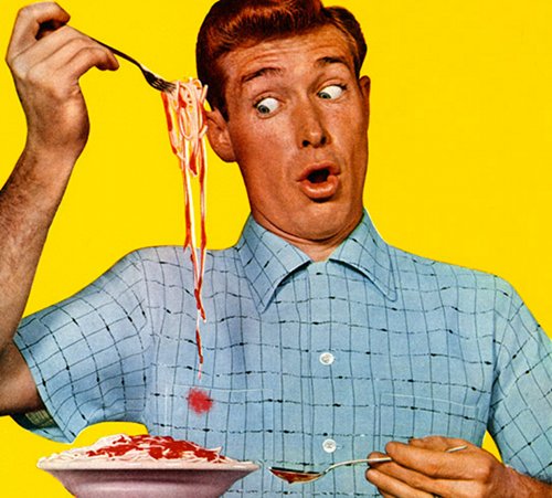 A man is enjoying a bowl of spaghetti while dealing with common clothing stains.