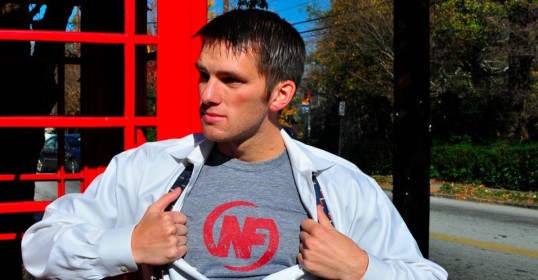 A man standing in front of a red phone booth, inspired by Nerd Fitness.