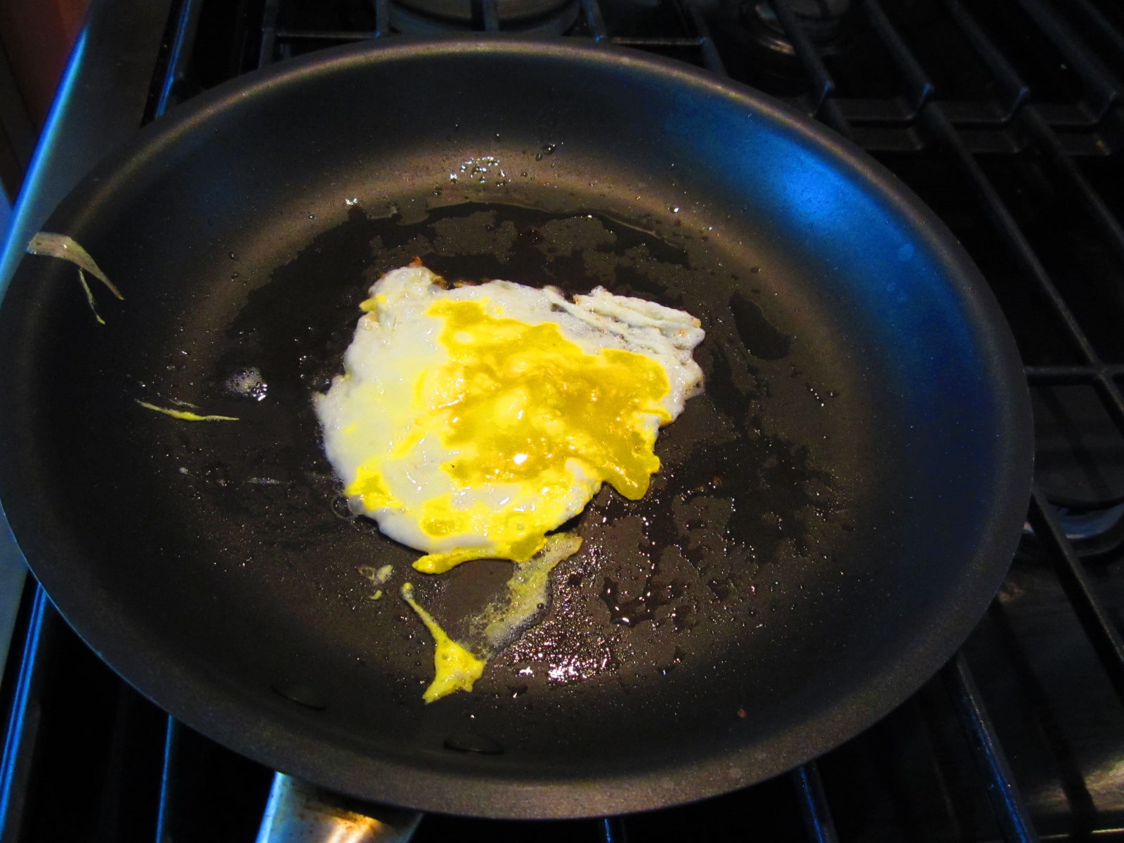 Vintage frying egg into frying pan.