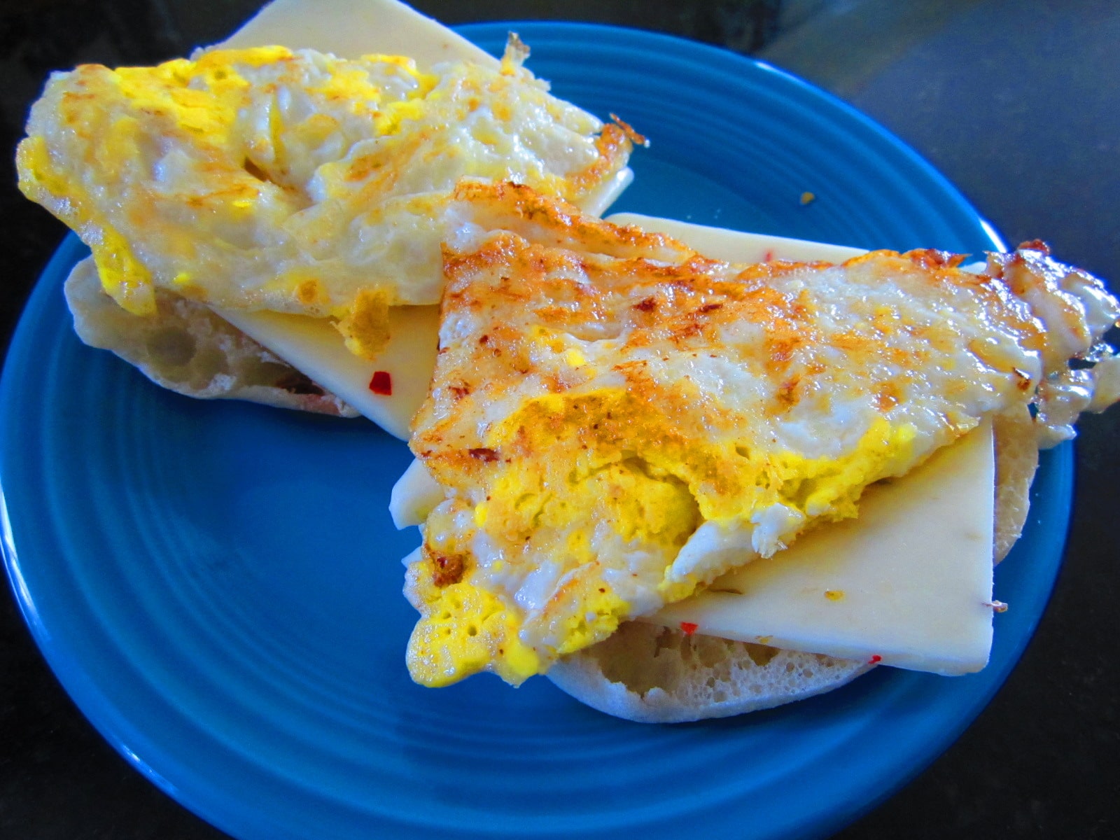 Egg next so that the cheese could melt between the toasted muffin and hot egg.