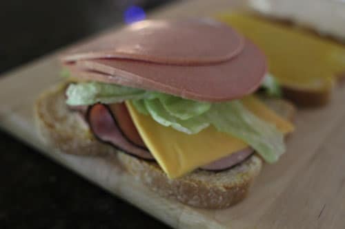 Vintage bologna to one slice of the mustard smeared Bread.