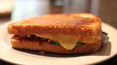 A Raspberry Twist grilled cheese sandwich is sitting on a plate.