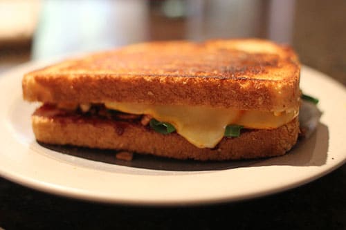 A Raspberry Twist grilled cheese sandwich is sitting on a plate.