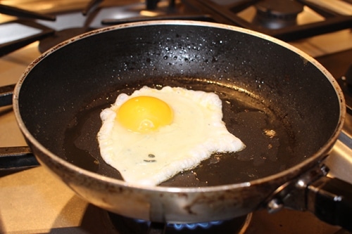Fried egg into frying pan.