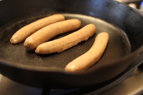 Frying the sausage on both sides.