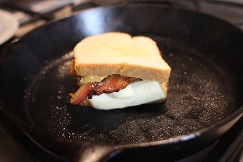 Vintage grill sandwich in a frying pan would a grilled cheese sandwich.