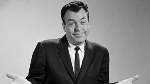 A black and white photo of a man in a suit, suitable for online comment.