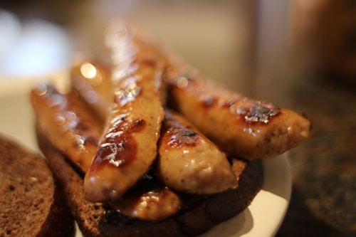 Vintage stacked fried sausage on bread.
