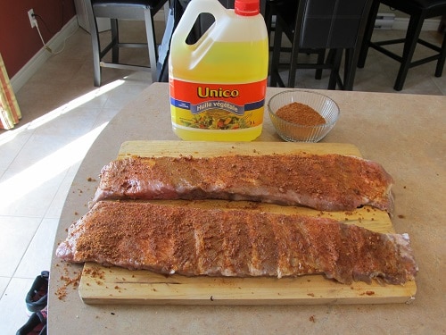 Applying dry rub to homemade BBQ barbecue pork ribs.