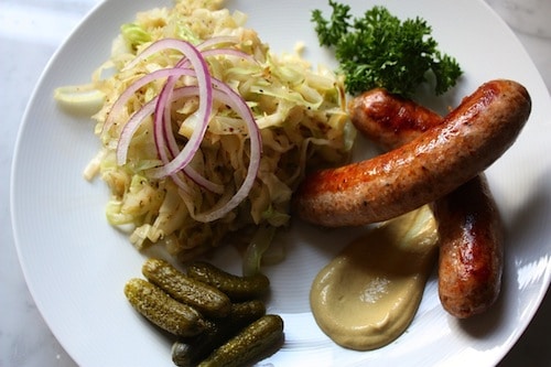 A low carb dish with sausage, pickles and sauerkraut.