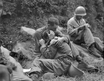 Vintage soldier crying being consoled hugged by another soldier.