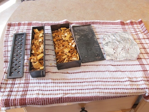 Woodchip smoker boxes on table.