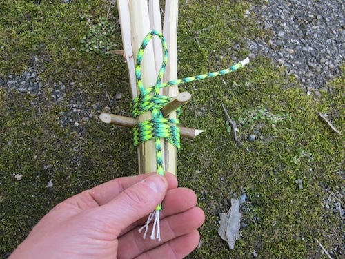 Firmly pull the bottom tail and the loop with grab the loose end of your cordage.
