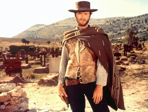 Good bad ugly clint eastwood standing with blanket around shoulders. 