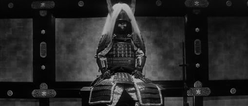 Vintage samurai in war gear preparing in private room.